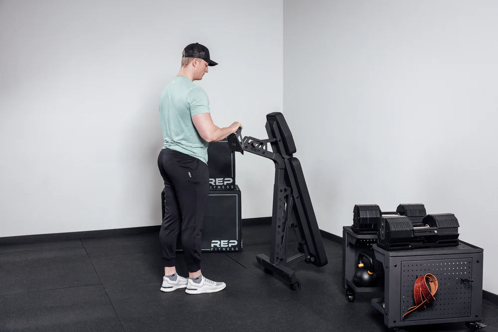 Rep Fitness - Nighthawk Adjustable bench being wheeled around - Gym Equip