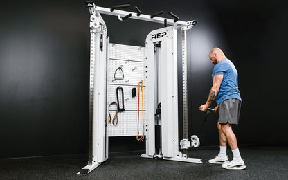 Rep Fitness - Arcadia Max functional trainer being used for bicep curls - White - Gym Equip