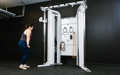 Rep Fitness - Arcadia Max functional trainer being used for tricep push downs - White - Gym Equip