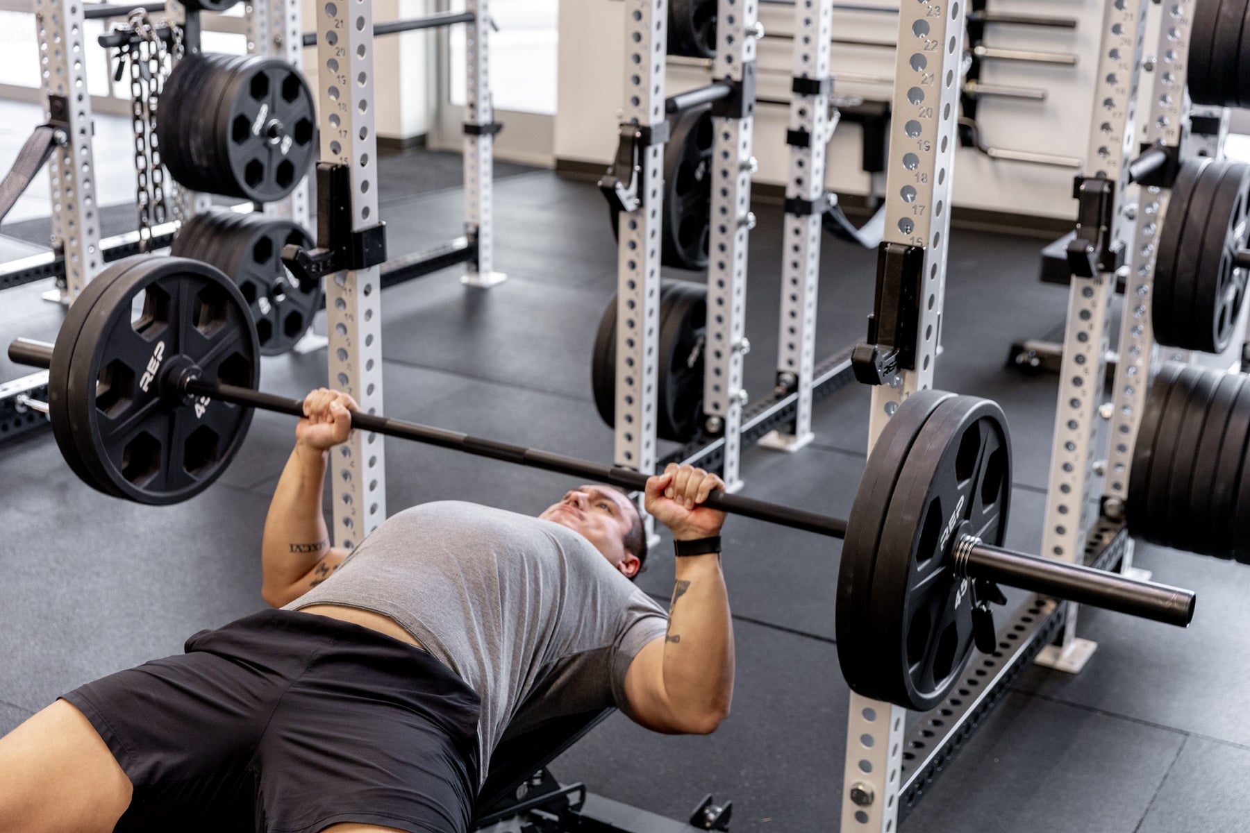 Rep Fitness - Black Diamond Black Cerakote being Bench pressed with Equaliser plates - Gym Equip